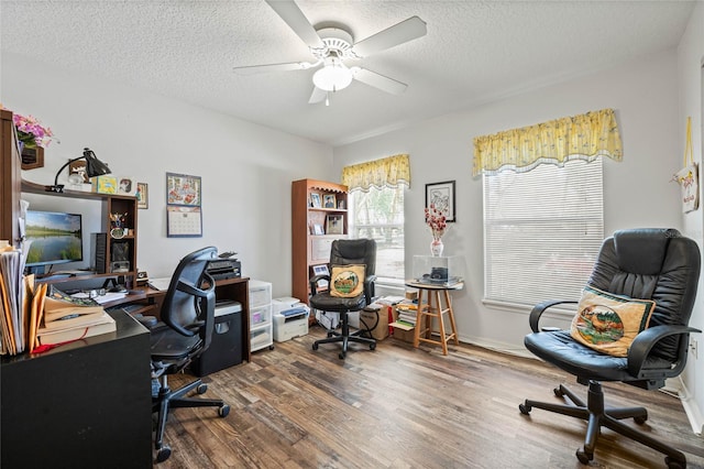 office featuring ceiling fan, a textured ceiling, baseboards, and dark wood-style flooring