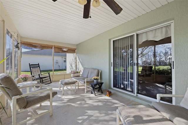 sunroom with a ceiling fan