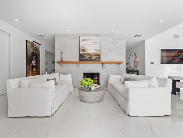 living area with a large fireplace, marble finish floor, visible vents, and recessed lighting