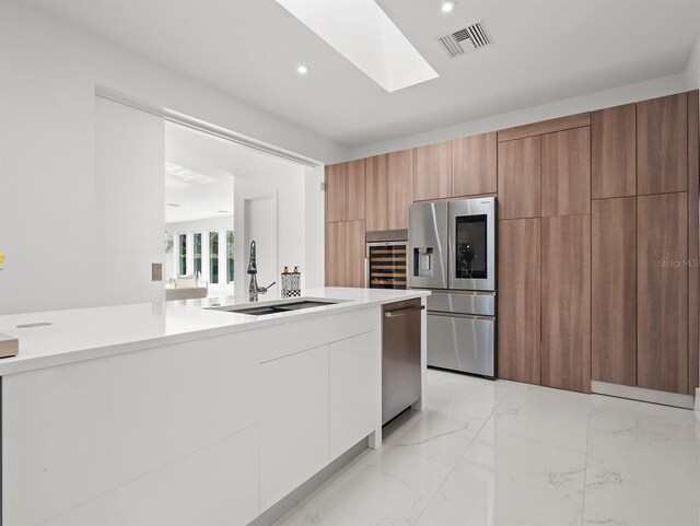 kitchen featuring visible vents, white cabinets, modern cabinets, stainless steel appliances, and light countertops