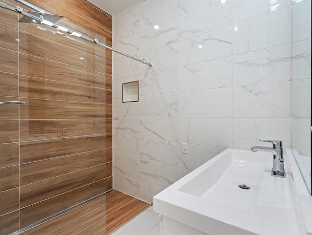 bathroom with a sink and tile walls