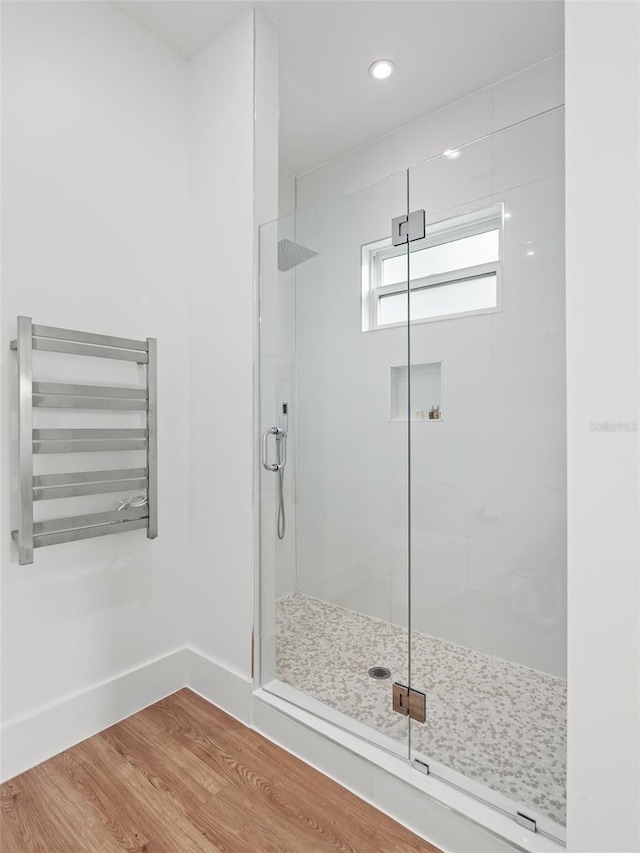 full bath with a stall shower, baseboards, wood finished floors, and recessed lighting