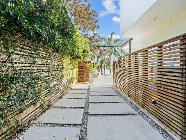 view of side of property featuring a patio and fence