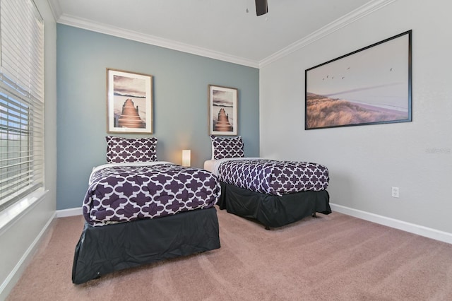 bedroom with baseboards, carpet flooring, a ceiling fan, and crown molding