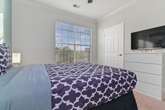 bedroom featuring carpet floors, a ceiling fan, visible vents, and crown molding