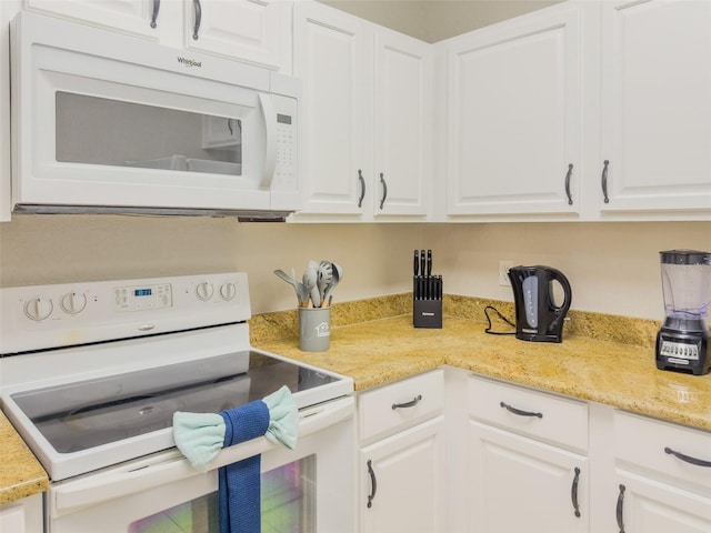 8000 Tuscany Way Unit 4405, Davenport, FL 33896 - kitchen with white appliances, white cabinets, and light stone counters