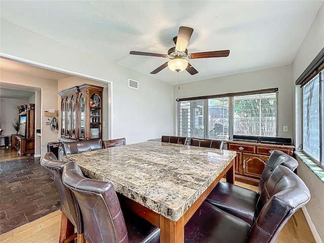 dining area featuring wood-type flooring and ceiling fan