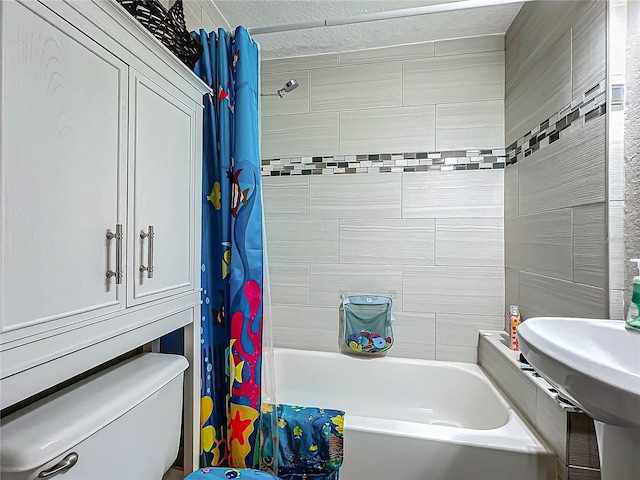 full bathroom featuring sink, toilet, and shower / tub combo