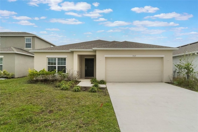 view of front facade with a front lawn, driveway, an attached garage, and stucco siding