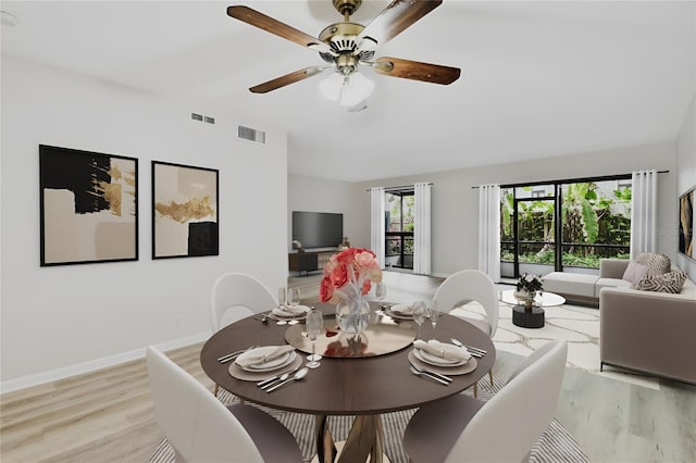 dining space with ceiling fan, light hardwood / wood-style flooring, and lofted ceiling