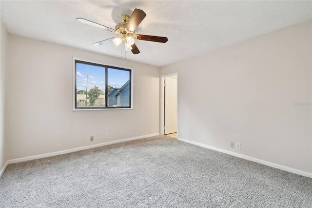 empty room featuring ceiling fan and light colored carpet