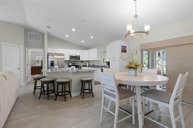 dining room with light wood-style floors, recessed lighting, visible vents, and a notable chandelier