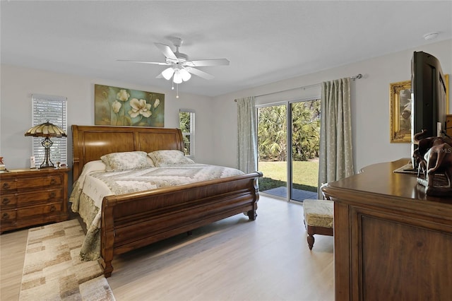 bedroom with access to exterior, light wood-style floors, and a ceiling fan