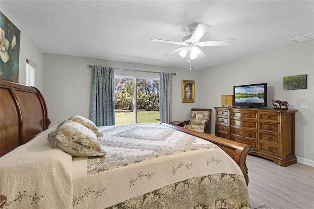 bedroom with ceiling fan, a textured ceiling, visible vents, access to outside, and light wood finished floors