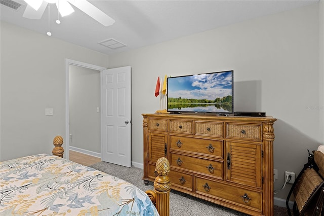 bedroom featuring light colored carpet, visible vents, ceiling fan, and baseboards