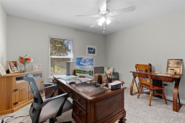 office featuring ceiling fan, baseboards, and light colored carpet