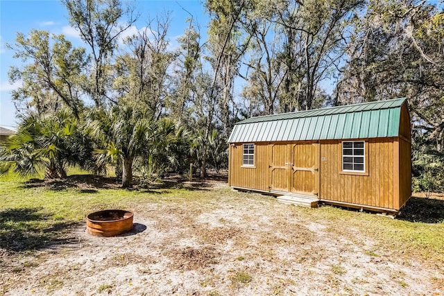 view of shed with an outdoor fire pit