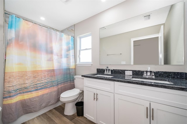 full bathroom with shower / tub combo, toilet, vanity, and wood-type flooring