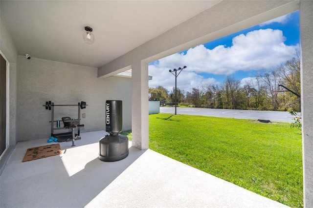 view of patio featuring basketball hoop