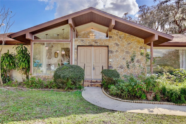 doorway to property with a yard