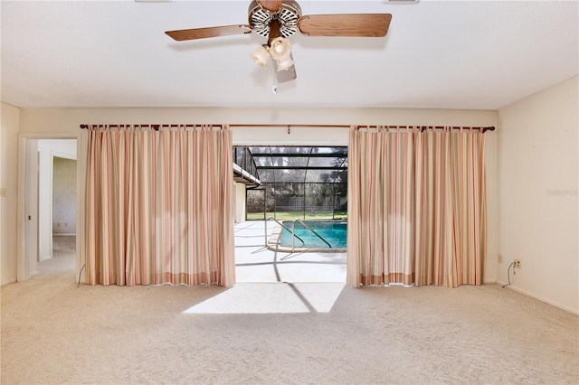 empty room featuring light carpet and ceiling fan