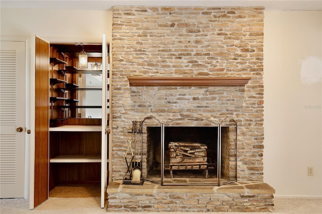 interior details with a brick fireplace and carpet flooring