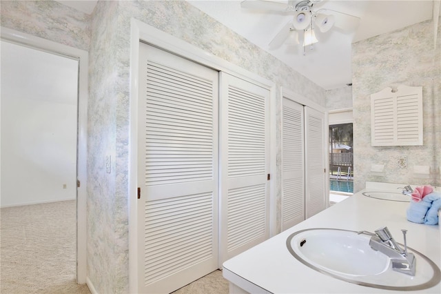 bathroom with ceiling fan and vanity