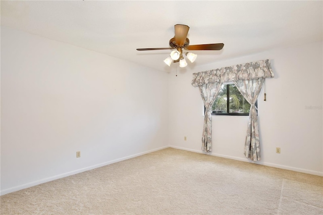 spare room with light carpet and ceiling fan