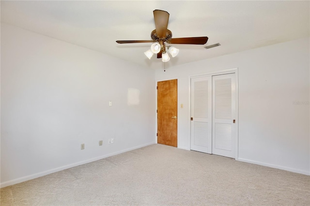 unfurnished bedroom featuring carpet, a closet, and ceiling fan