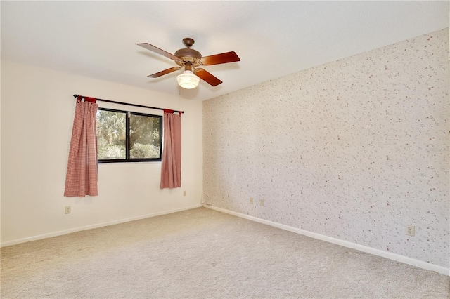 unfurnished room with ceiling fan and carpet floors