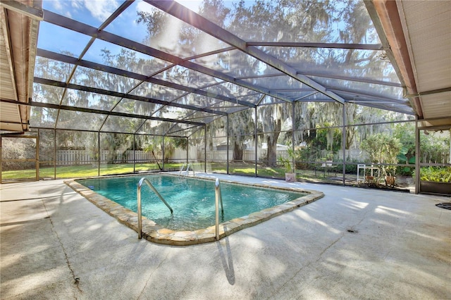 view of pool featuring a patio area and glass enclosure