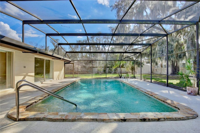 view of swimming pool featuring a patio and a lanai