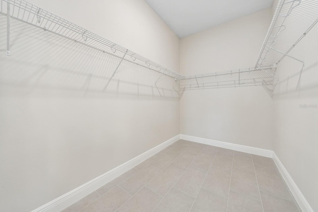 walk in closet with light tile patterned flooring