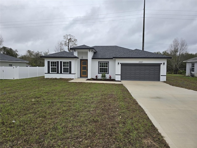 view of front of property featuring a garage, concrete driveway, fence, a front yard, and stucco siding