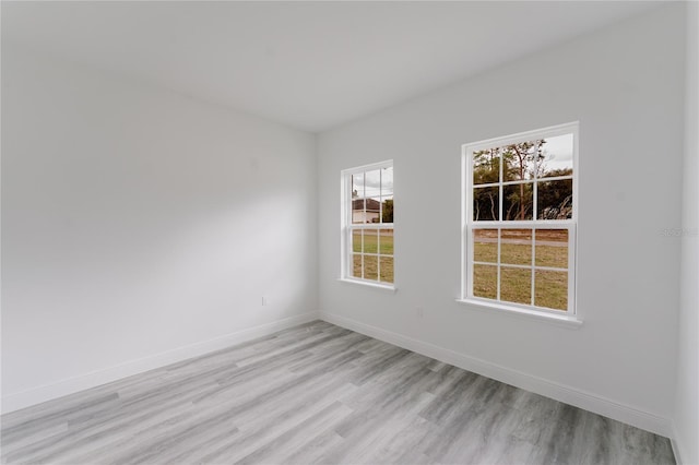 unfurnished room featuring light wood-style floors and baseboards