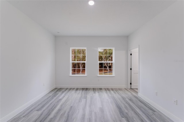 unfurnished room with light wood-style floors and baseboards