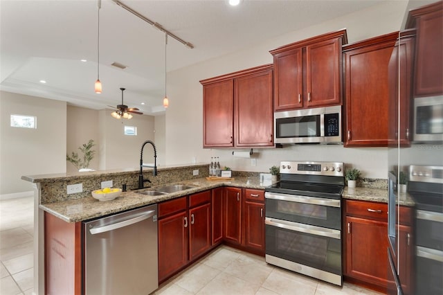 kitchen with reddish brown cabinets, stainless steel appliances, visible vents, a sink, and a peninsula