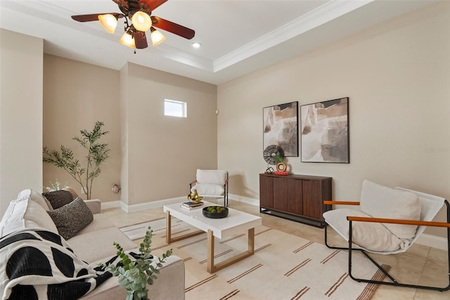 living room with recessed lighting, a raised ceiling, ornamental molding, a ceiling fan, and baseboards