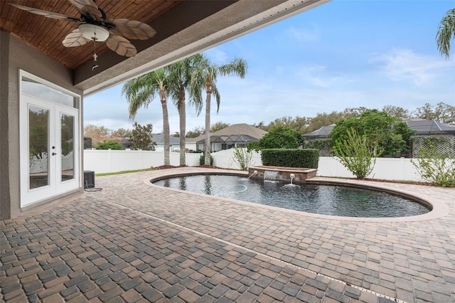 view of pool with ceiling fan, a fenced backyard, french doors, a fenced in pool, and a patio area