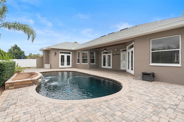 view of pool featuring ceiling fan, fence, a patio, and french doors