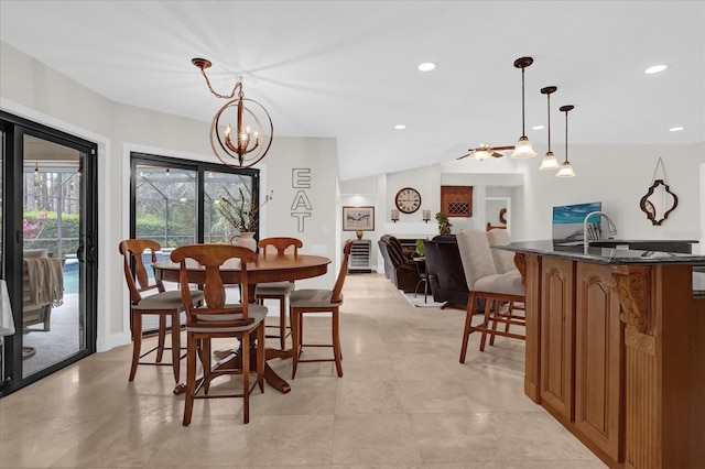 dining room featuring lofted ceiling, a notable chandelier, and recessed lighting