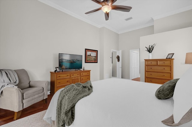 bedroom with ceiling fan, visible vents, crown molding, and wood finished floors