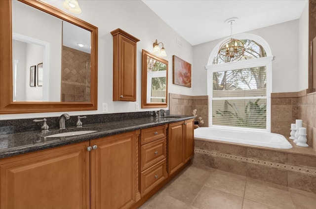 full bath with a garden tub, double vanity, tile patterned flooring, and a sink