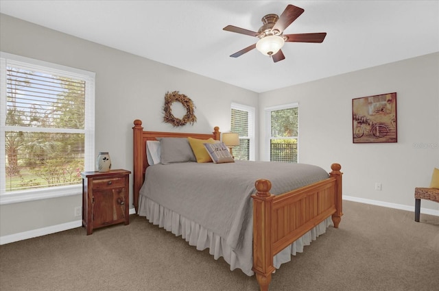 carpeted bedroom with baseboards and a ceiling fan