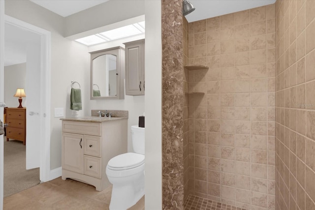 full bath featuring tile patterned floors, vanity, toilet, and a walk in shower