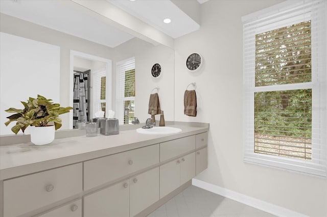 bathroom featuring baseboards and vanity