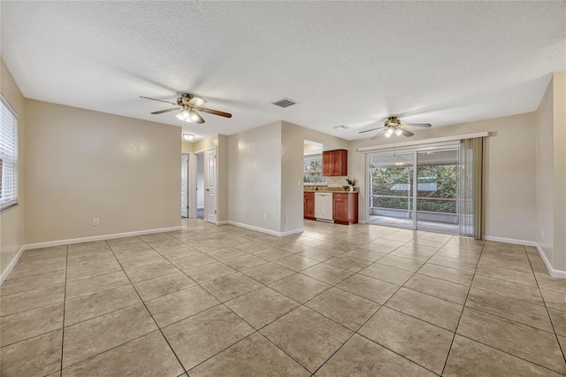 unfurnished living room featuring a textured ceiling, baseboards, visible vents, and a ceiling fan