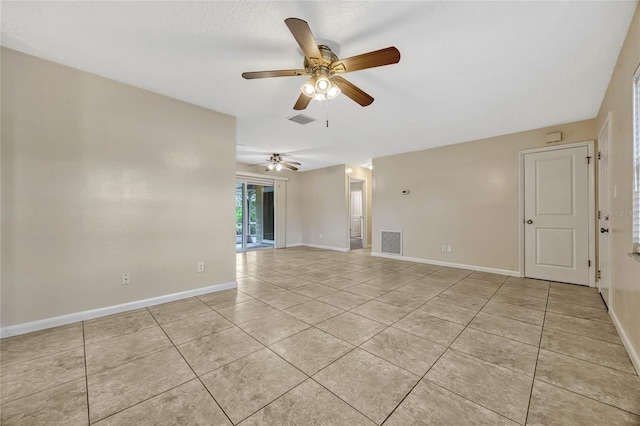 spare room featuring a ceiling fan, visible vents, baseboards, and light tile patterned flooring