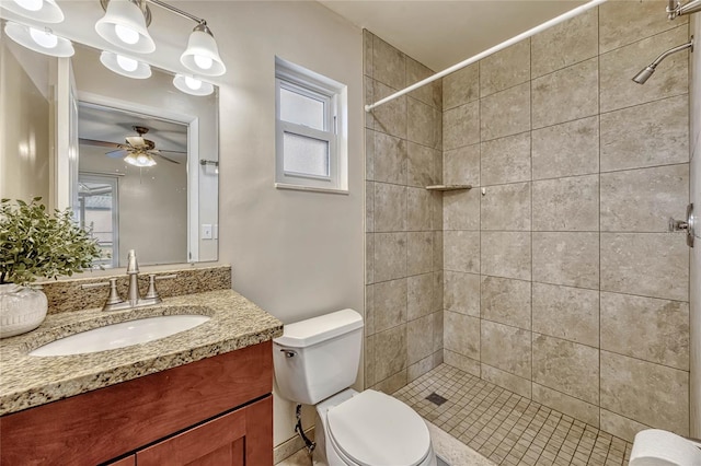 full bath featuring toilet, ceiling fan, a shower stall, and vanity