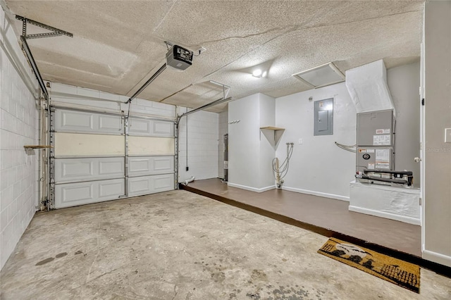 garage with a garage door opener, concrete block wall, electric panel, and baseboards